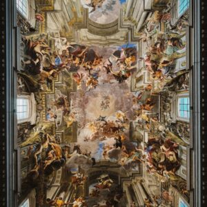 Intricate fresco artwork on a church ceiling in Rome, Italy.